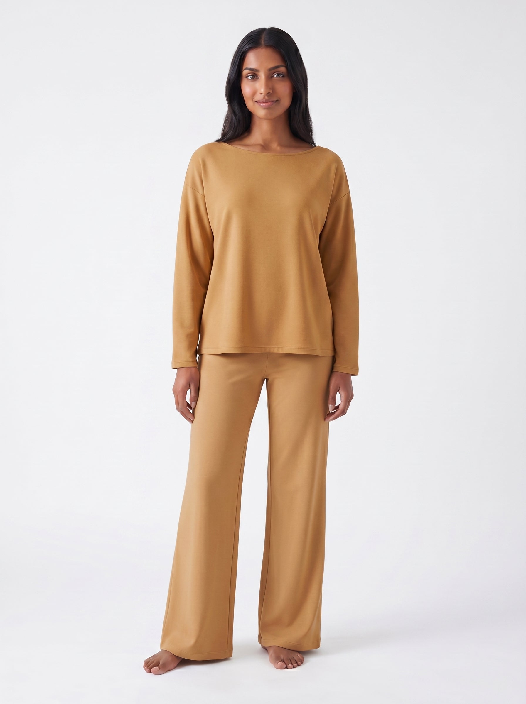 Woman wearing a Caramel bamboo loungewear set on a white 