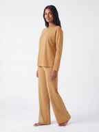 Woman wearing a Caramel bamboo loungewear set on a white 