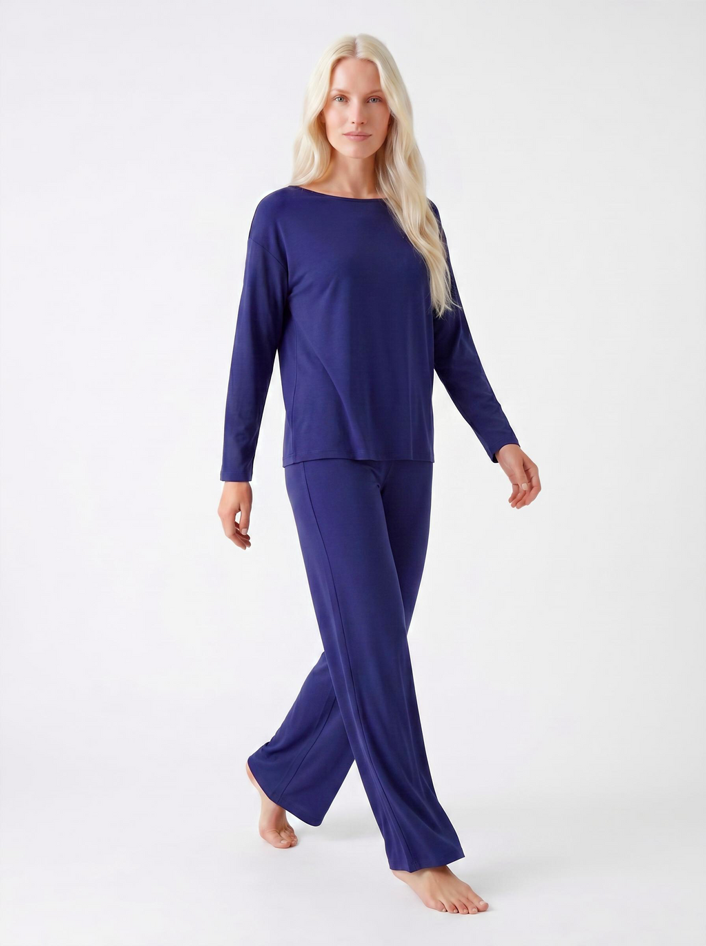 Woman wearing a midnight blue bamboo loungewear set on a white background